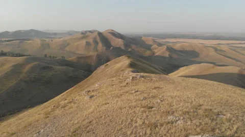 Slow direct aerial flight over bald steppe mountains. Orenberg, South Ural Video stock 155999029