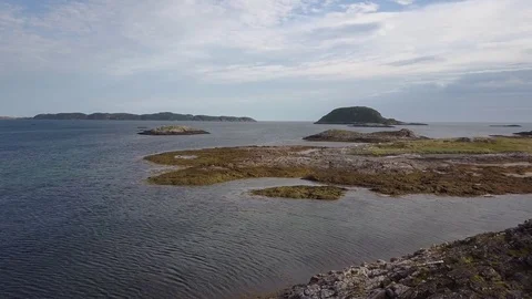 Slow direct aerial flying above rocky islands, tundra. Barents sea. Video stock 84065166