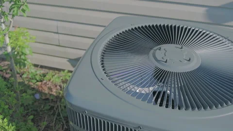 Slow Dolly back and rotating ac unit with fan spinning Stock Footage 132444393