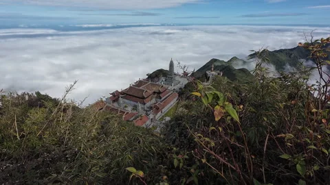 Slow dolly back shot of temple and sea of clouds on Fansipan Stock Footage 295344930