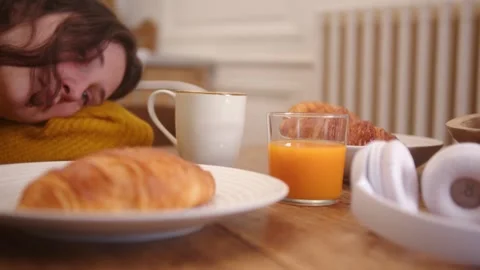 Slow dolly lateral shot of a table set for breakfast, a pair of headphones Stock Footage 259174088