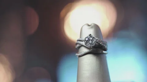 Slow dolly left of large diamond ring with multiple bands intersecting Stock Footage 130671925