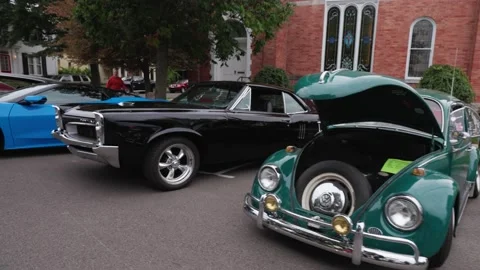 Slow dolly type shot down street full of classic cars Stock Footage 240059356