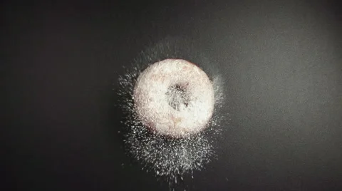 SLOW: A donut falls on a black table (top view) Stock Footage 62827965