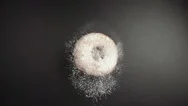 Slow: A Donut Falls On A Black Table (Top View) Stock Footage