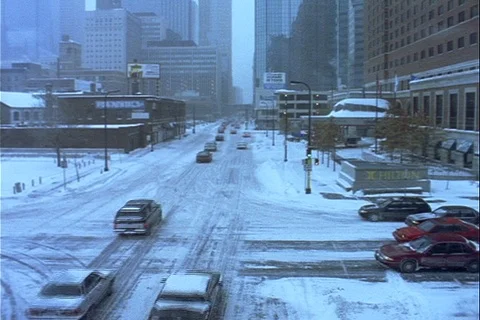 Slow downtown winter traffic intersection during snow Stock Footage 121542194
