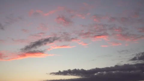Slow drifting evening clouds glowing in soft sunset light Stock Footage 335873949