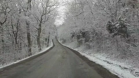 Slow drive down a snowy country road Stock Footage