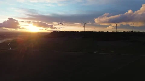 Slow Drone Approach to Wind Turbines on Hill at Sunset Silhouette Stock Footage 325796973