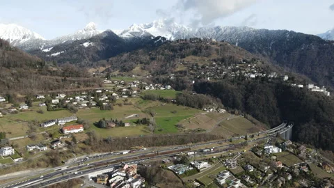 Slow drone flight forward over alpine village and mountains, Switzerland 動画素材 329355223