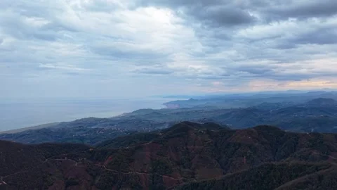 Slow Drone Flight From Hills Toward the Coast Under Overcast Sky in 4K Stock Footage 339022382