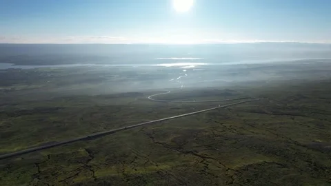 Slow drone flight over highland road with backlit sun, Fjardarheidi Iceland Stock Footage 346551839
