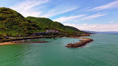 Slow Drone Flight Toward Harbor and Lighthouse Along the Coast in 4K Video stock 337790666
