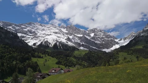 Slow Drone Flight Toward Snow-Capped Swiss Alps in Engelberg Stock Footage 336814974