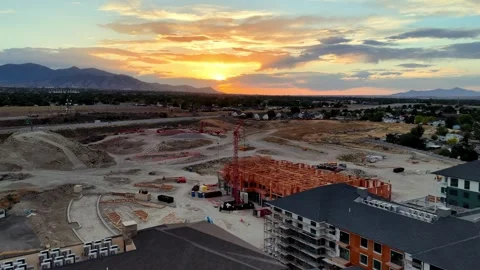 Slow drone forward flyover above apartment construction at sunset in Stock Footage 340321275