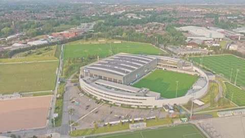 Slow drone forward flyover establishing Manchester City Academy Stadium at City Stock Footage 341902732