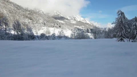 Slow drone low flight over fresh snow in mountains landscape. alps 4k Stock Footage 147858692