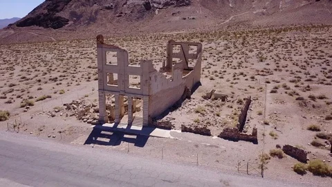 Slow drone over ghost town buildings - old bank Stock Footage 92828656