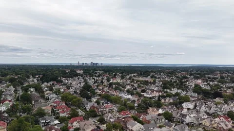 Slow drone pan across Mount Vernon homes and tree-lined streets near New Stock Footage 345422944