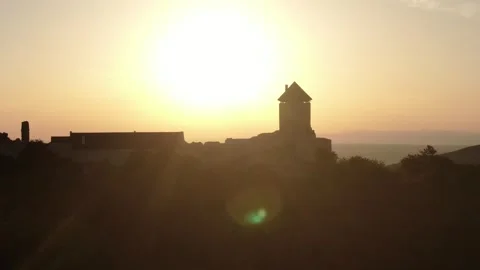 Slow Drone Pan of Medieval Castle Silhouette at Golden Sunset 動画素材 337305516