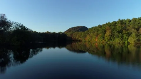 Slow drone pan over Lake near mountain in woods Video stock 83147332
