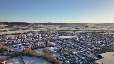 Slow Drone Pan over Small Snow covered UK village in 4K Видео 329968185