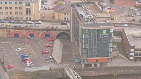 Slow drone pull-out from Holiday Inn Express signage, Kelham Island industrial Video stock 325180013