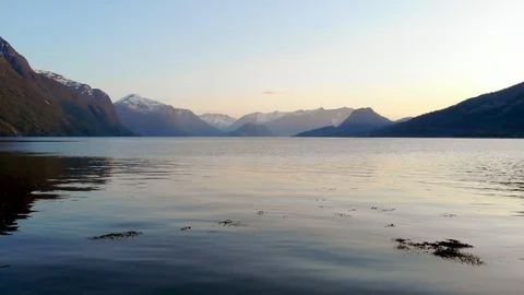 Slow drone pull out shot of a fjord in Norway, blue hour Video stock 105667254
