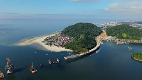 Slow drone pull out showing Ponte de Guaratuba connecting Matinhos with Stock-Footage 313619568