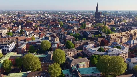 Slow drone pullback over Église Saint-Thomas and Cathédrale Notre-Dame de Stock Footage 339057999
