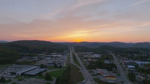 Slow Drone Push Toward Sunset as Sun Sets Behind Mountain Horizon Stock Footage 321379418