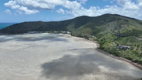 Slow drone tracking shot in daytime, moving sideways to the right along Hayman Stock Footage 331025283