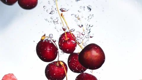 Slow drop of blueberry strawberry raspberry into water on white background Video stock 156814383