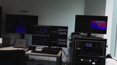 Slow establishing shot of multiple screens and computers set up for the Stock Footage 244787951