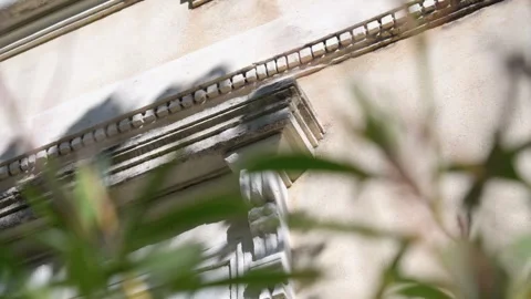 Slow establishing shot of stone decorations of the exterior of a villa in Stock Footage 274463346