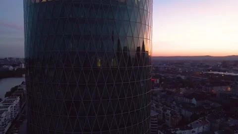 Slow evening orbit around round glass tower by Main Stock Footage 331875550