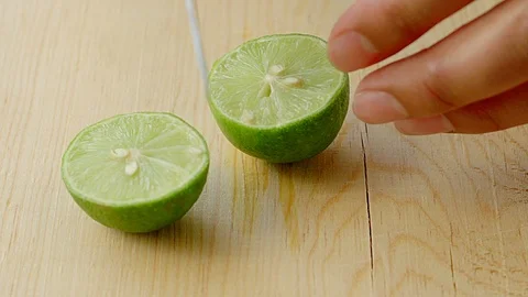 SLOW TO EXTREME CLOSE UP TO A HALF OF A LEMON Stock Footage 107308265