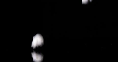 Slow fall of popped popcorn on dark background Stock Footage 55880023