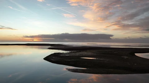 Slow flight along beach towards sunrise Stock Footage 320832769