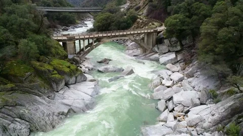 Slow flight approaching old arched bridge Stock Footage 136750895
