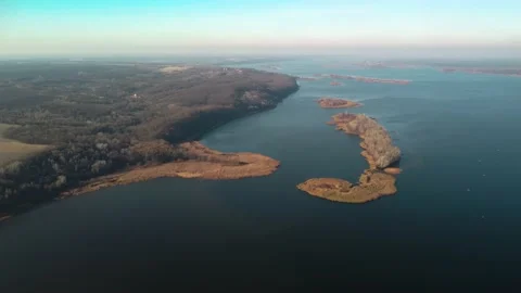 Slow flight of a drone over the autumn forest and attractive river. Bird's eye Stock Footage 165453155