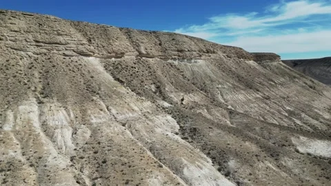 Slow flight in the mountain desert with a descent in the canyon Stock Footage 237743696