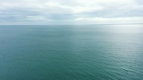 Slow flight over a calm blue sea Vídeo Stock 167739226
