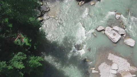 Slow flight over a fast mountain river , blue cold water in a mountain river Stock Footage 230997501