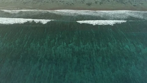 Slow flight over the ocean surface. Smooth flight over crystal clear waters. Stock Footage 148471063