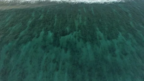 Slow flight over the ocean surface. Smooth flight over crystal clear waters. Stock Footage 148471229