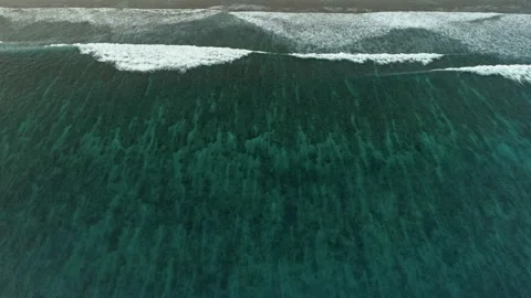 Slow flight over the ocean surface. Smooth flight over crystal clear waters. Stock Footage 148471326