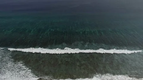 Slow flight over the ocean surface. Smooth flight over crystal clear waters. Stock Footage 148472322