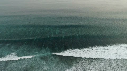 Slow flight over the ocean surface. Smooth flight over crystal clear waters. Stock Footage 148472394