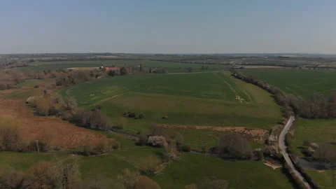 Slow flight over the patchwork of fields and roads in Oxfordshire Stock Footage 152651925